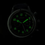 Luminous night glow demonstration of green dial numerals and cathedral hands in darkness