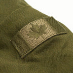 Close-up of the subdued olive embroidered Canadian maple leaf flag patch on the right sleeve of the jacket.