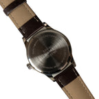 Close-up of the stainless steel case back of the 1960s Pakistani Airman replica watch, showing engraved military-style markings.