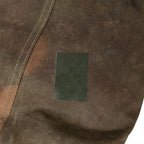Detailed view of a green adhesive patch on the waterproof canvas material of the Hungarian tent.