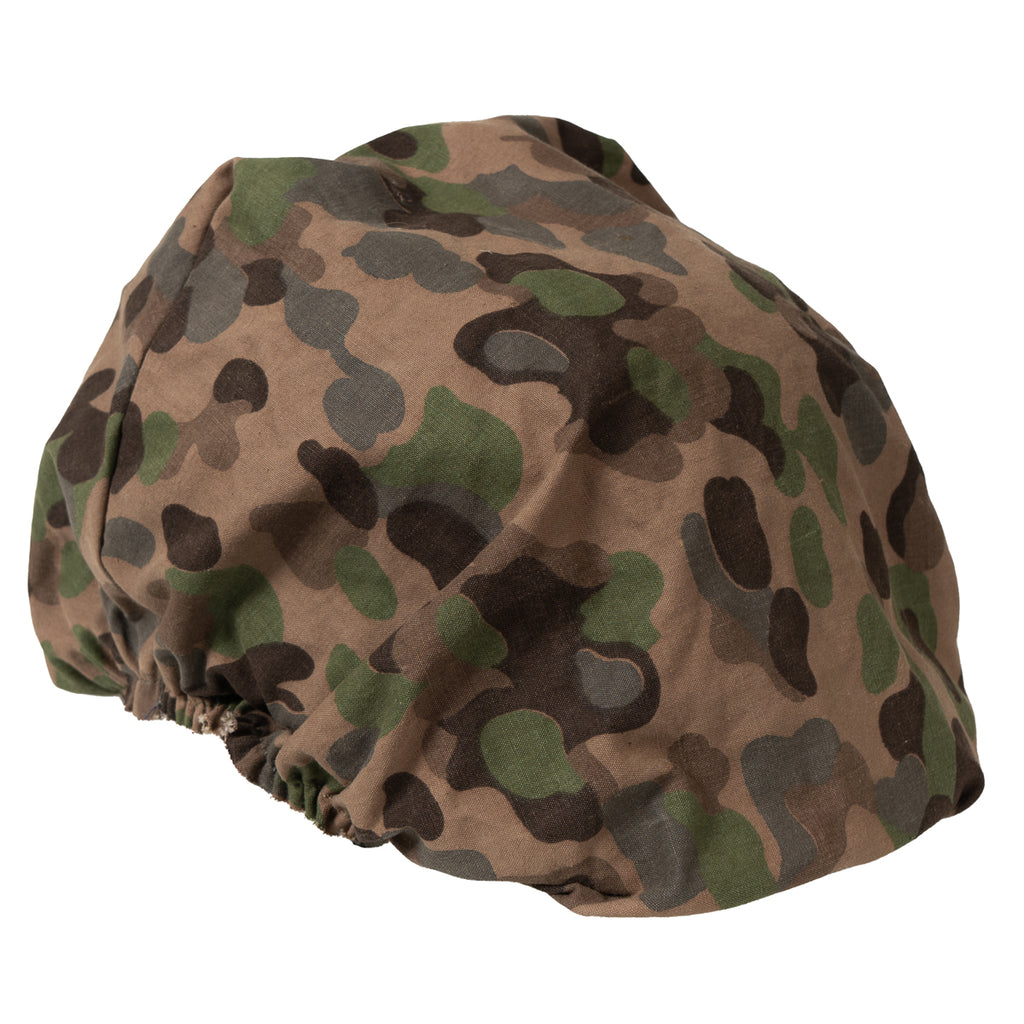 Three-quarter angle view of the Austrian military M75 helmet cover featuring the woodland pea-dot camo print.