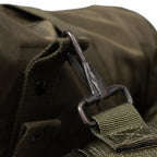 Close-up of a green bag with a buckle and strap on a blurred background