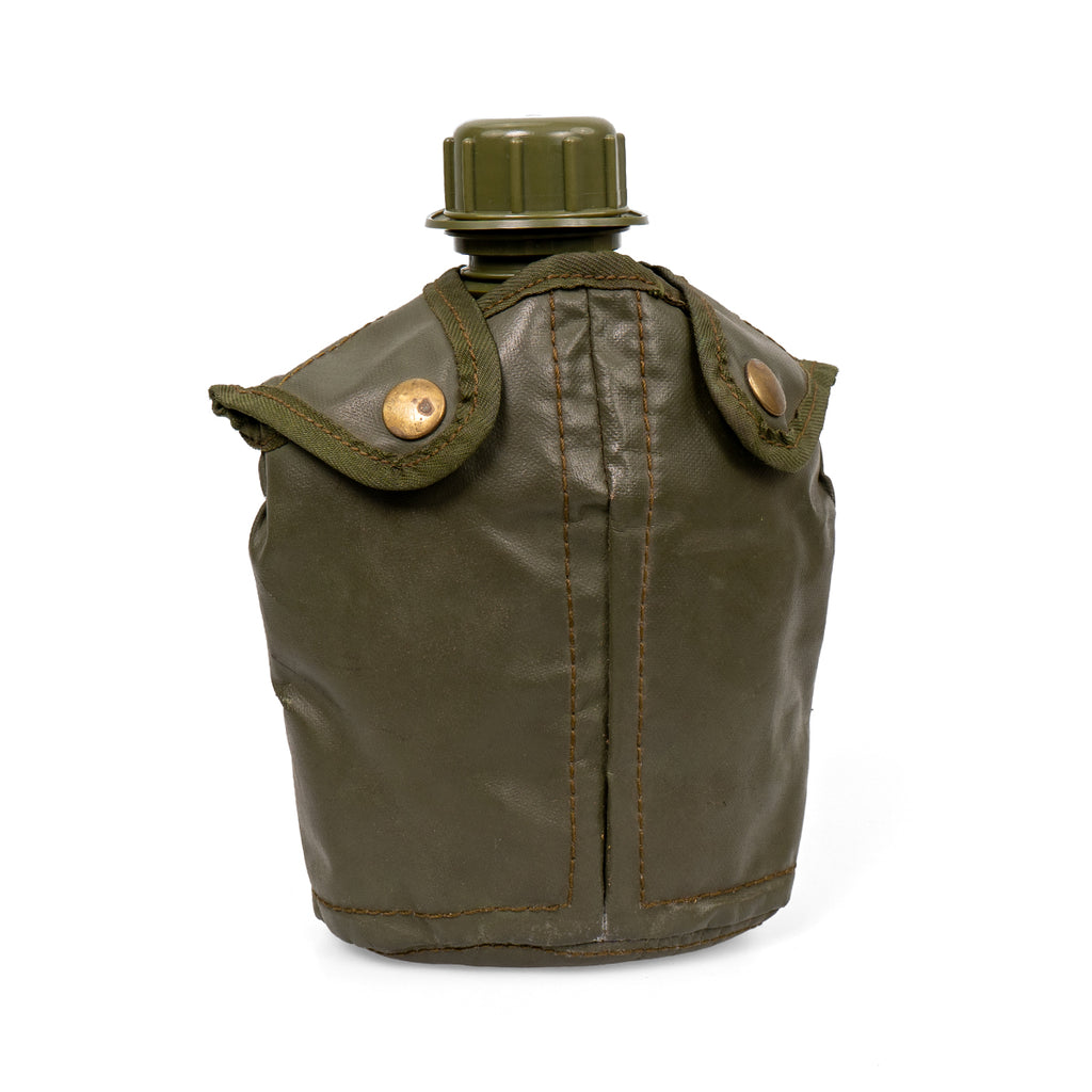 The 750ml Belgian military canteen inserted into its insulated olive green vinyl cover, featuring secure brass snap buttons.
