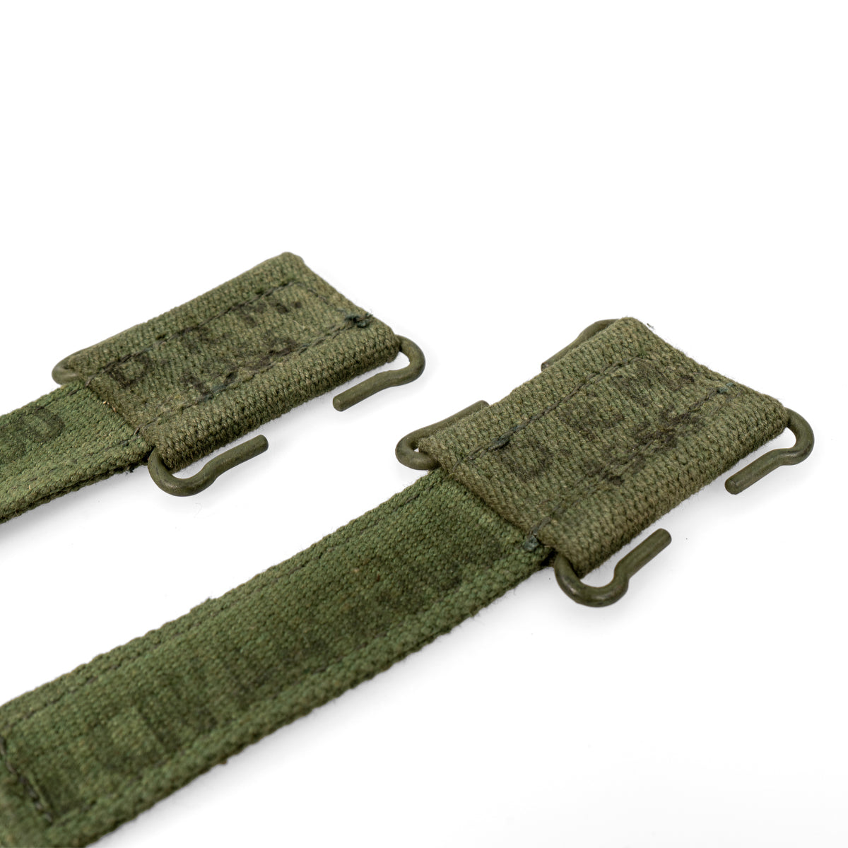 Close-up detail of the metal attachment hooks on the original 1950s British Army 44 Pattern webbing strap extenders.
