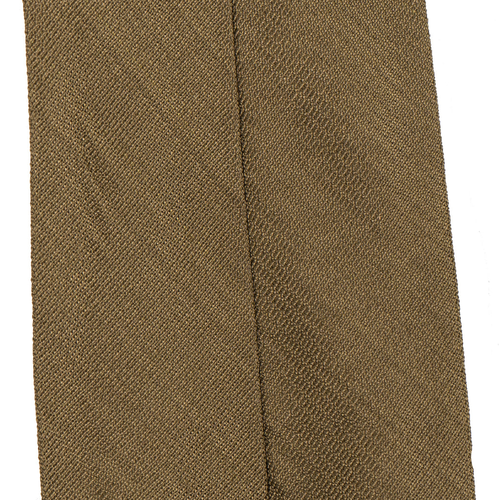 Macro close-up of the vintage khaki rayon fabric on a British WW2 army tie, revealing the subtle diamond-like texture and weave.