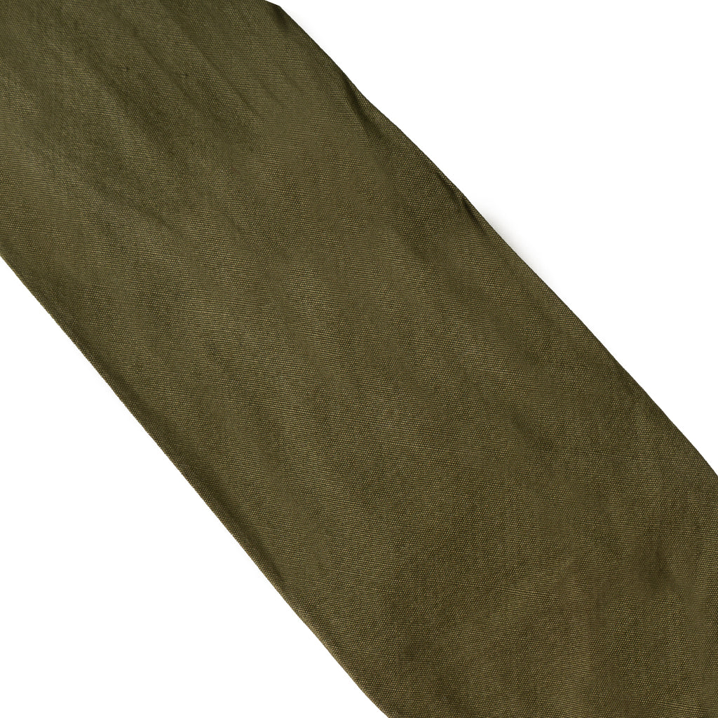 Detailed view of the hard-wearing khaki green fabric weave characteristic of post-war British Army uniform ties.