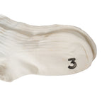 Close-up detail of the toe area of British Navy surplus socks featuring the classic black numeral 3 print.