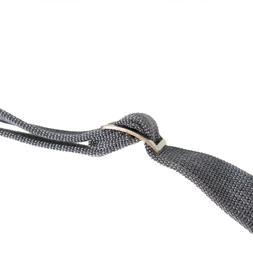 Detail of the adjustable metal sliding buckle on the heavy-duty Cold War era East German military utility sling.