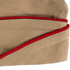 Close-up detail of a vintage US Army Khaki Garrison Cap showing the texture of the cotton twill and red piping trim.