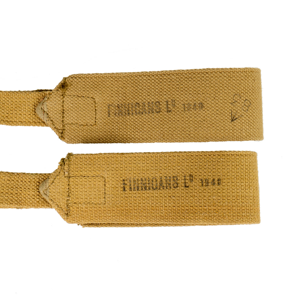 Close-up of khaki 37 Pattern cross straps showing original stamped maker markings and date.