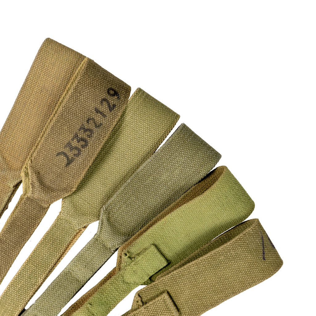 Varied collection of khaki 37 Pattern webbing straps, showcasing different canvas textures and wear levels.