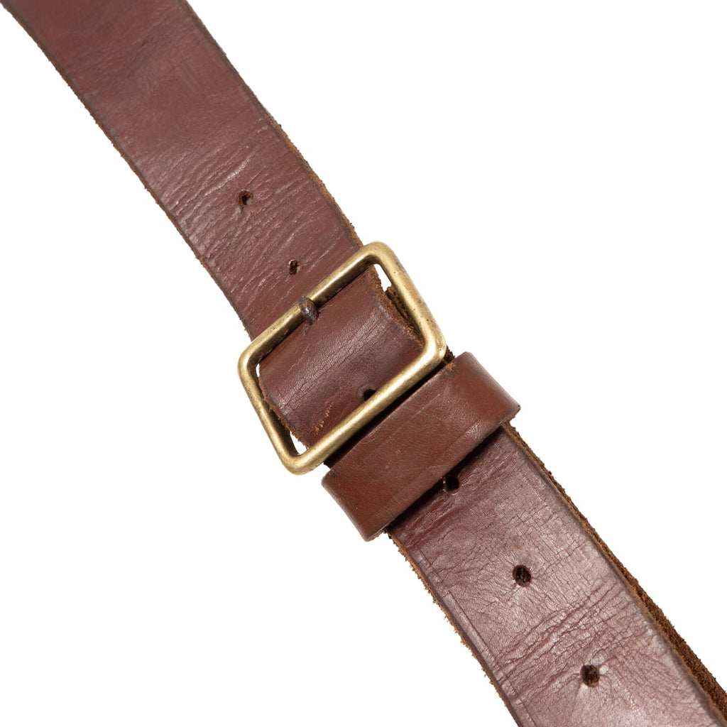 Close-up of the brass-coloured metal buckle and adjustment triangle on a WW2 South African Pattern 1903 leather ammunition strap.
