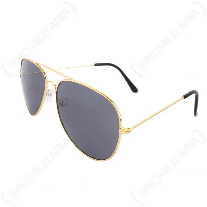 Angled profile of US pilot sunglasses showing gold temples, black ear tips, and clear nose pads