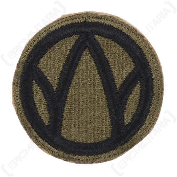 Front view of original US 89th Infantry Division shoulder patch featuring black Rolling W emblem on olive green background