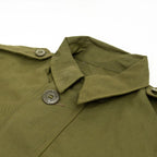Detailed close-up of the collar and shoulder epaulette button on the unissued Canadian GS Mk II coat.