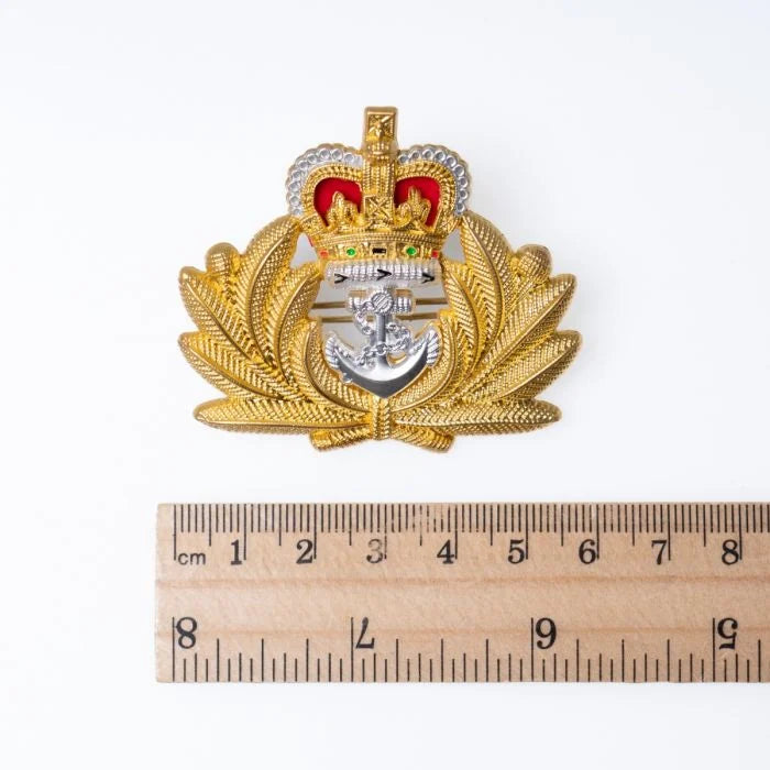 Original British Royal Navy Officer cap badge placed next to a ruler measuring approximately 5.5 centimetres in width