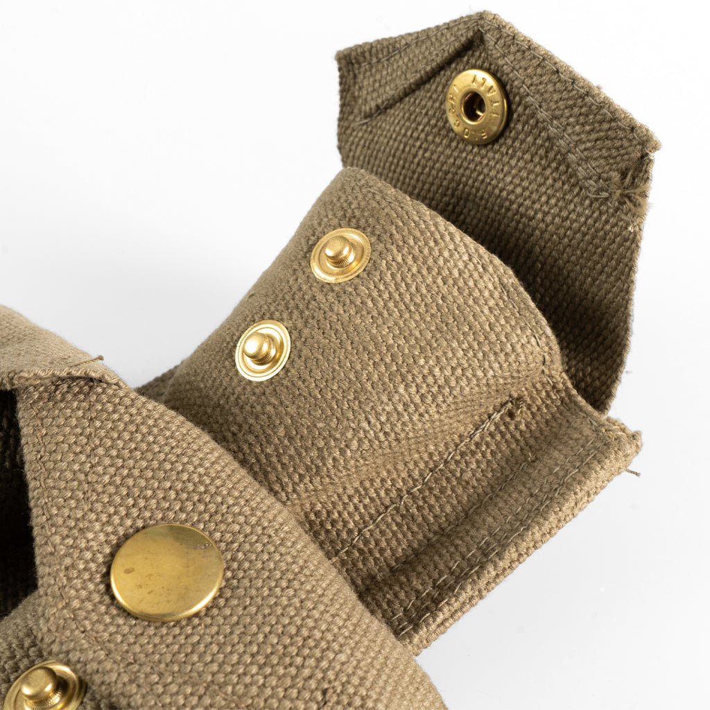 Close-up of Italian 37 Pattern pouch showing open brass snap fasteners and the durable canvas weave construction.