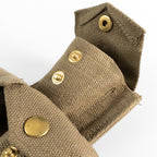 Close-up of Italian 37 Pattern pouch showing open brass snap fasteners and the durable canvas weave construction.
