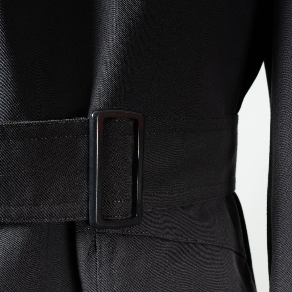 Detail shot of the adjustable waist belt and durable black buckle on the authentic German military trench coat.