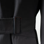 Detail shot of the adjustable waist belt and durable black buckle on the authentic German military trench coat.
