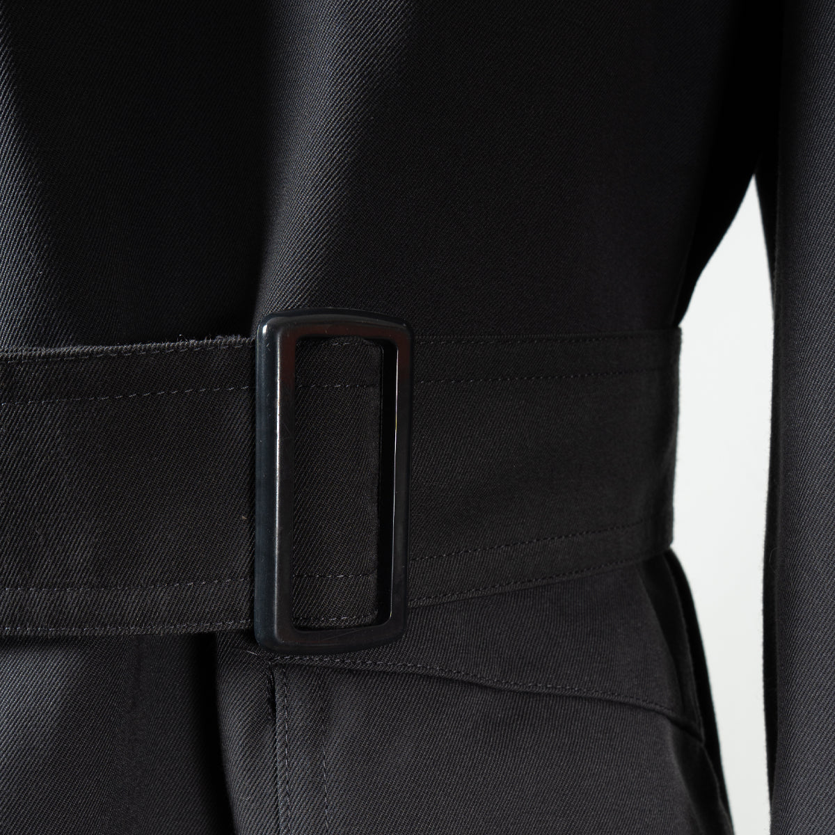 Detail shot of the adjustable waist belt and durable black buckle on the authentic German military trench coat.