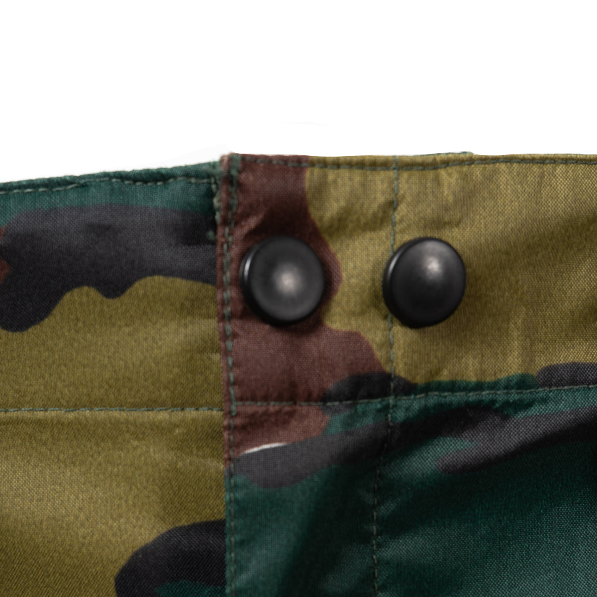Detail view of front waistband buttons on genuine Belgian military Gore-Tex rain trousers.