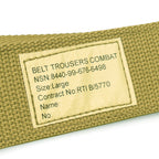 Close-up of the military specification label on a British Army webbing belt featuring text for Belt Trousers Combat and NSN details.