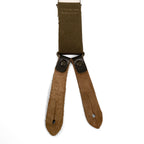 Reverse view of Bundeswehr suspender leather tabs, showing the natural suede texture and buttonhole details for secure trouser attachment.