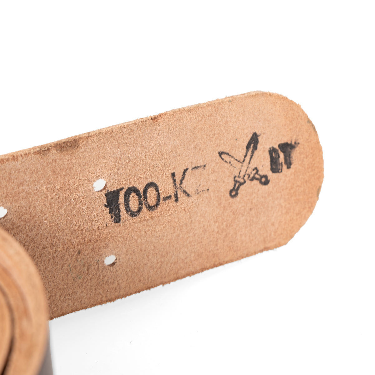 Close-up of internal black markings on the Czech Army leather belt showing 'TOO-K' text and a crossed swords insignia.