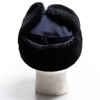 Rear view of a navy blue surplus East German Army Ushanka hat, showcasing the durable construction and folded ear flaps.