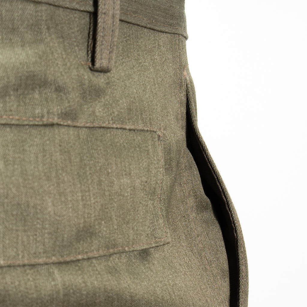 Close-up of the rear flap pocket detailing on durable East German NVA military trousers, showcasing authentic stitching.