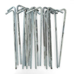 Collection of approximately 10 galvanised steel tent pegs in surplus condition with typical signs of wear and rust.