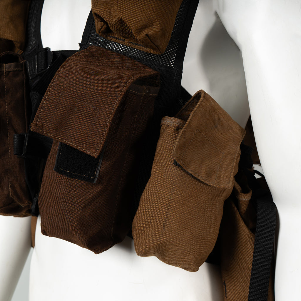Close-up detail of the magazine pouches on a vintage SADF Pattern 83 battle jacket, showing the heavy-duty construction and reinforced flaps designed for secure storage.