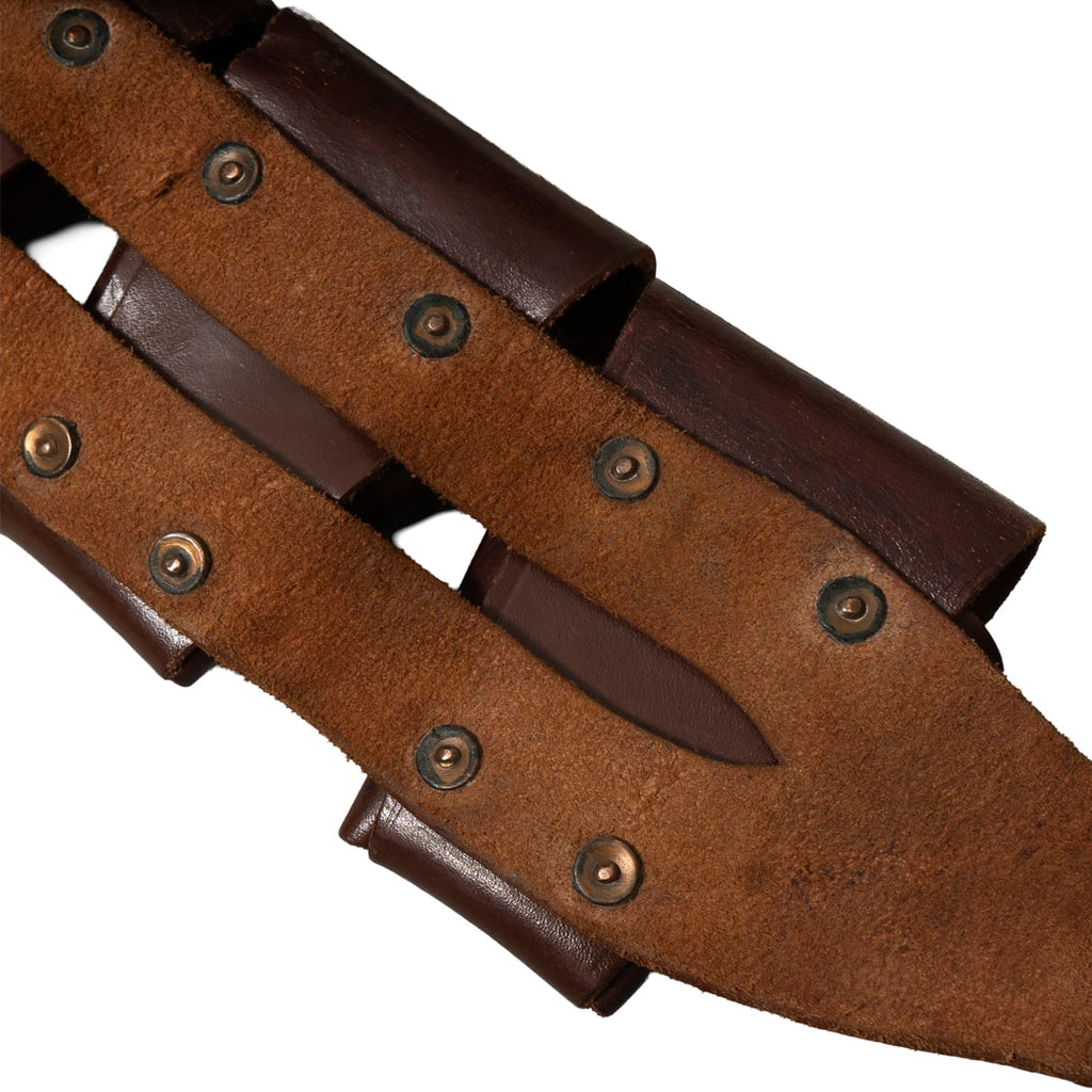 Reverse side of a WW2 South African leather bandolier showing internal construction, heavy-duty rivets, and rugged leather texture.