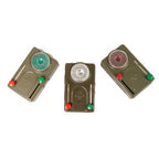 Three Cold War era Swiss Army signalling torches showing variations in red, green, and clear lens positions.