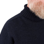 Close-up detail of wide ribbed waist hem on navy blue wool jumper