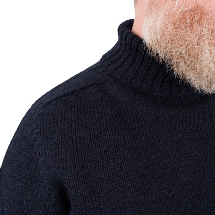Close-up detail of wide ribbed waist hem on navy blue wool jumper