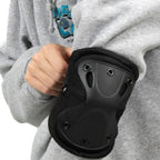 Black Rothco Low Profile Tactical Elbow Pad fitted on user arm over jacket sleeve