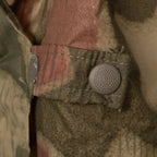 Close-up of the adjustable side strap and textured snap closure of the BGS Sumpftarn poncho.