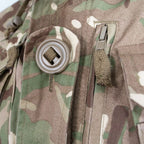 Close-up of chest pocket with large slotted Canadian button and vertical zipped map pocket