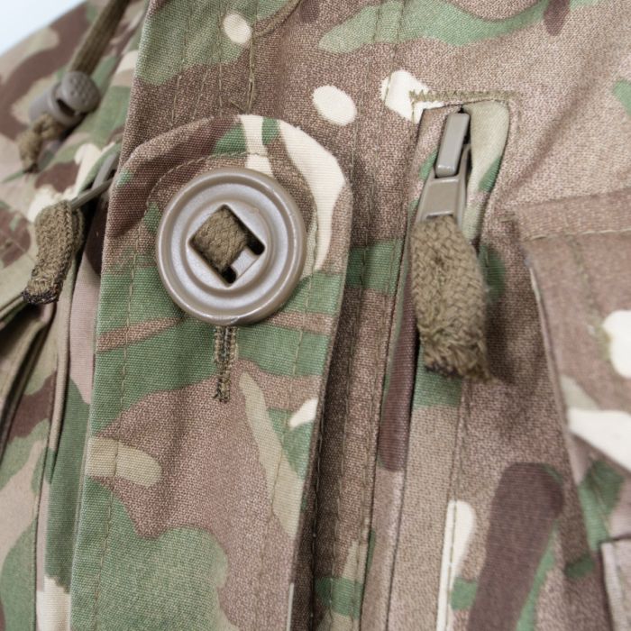 Close-up of chest pocket with large slotted Canadian button and vertical zipped map pocket