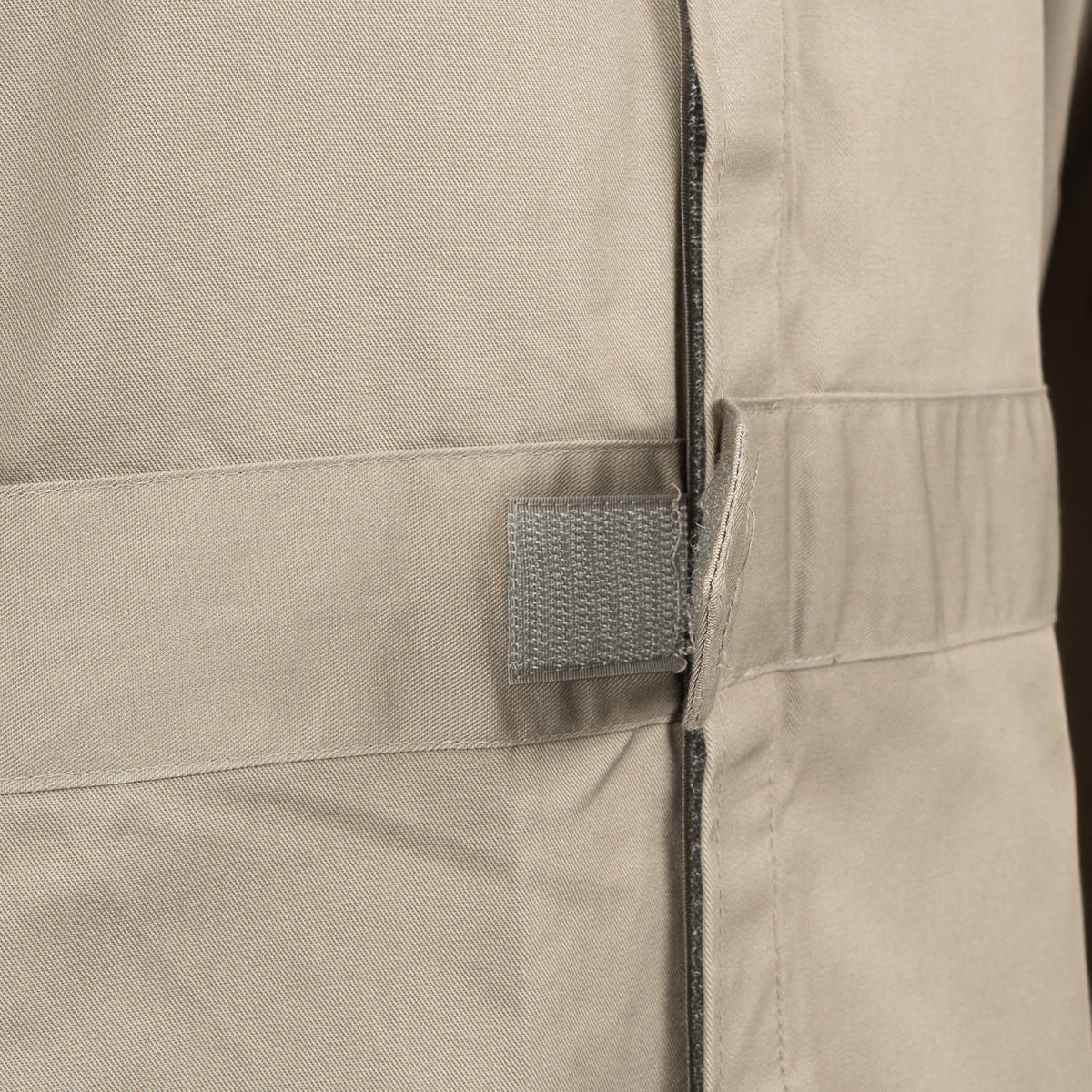 Close-up of the robust hook-and-loop waist adjuster on the RAF coveralls, designed for a customized, secure fit.