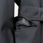 Side view focusing on the large, practical flap pocket detail found on the German Army trench coat.