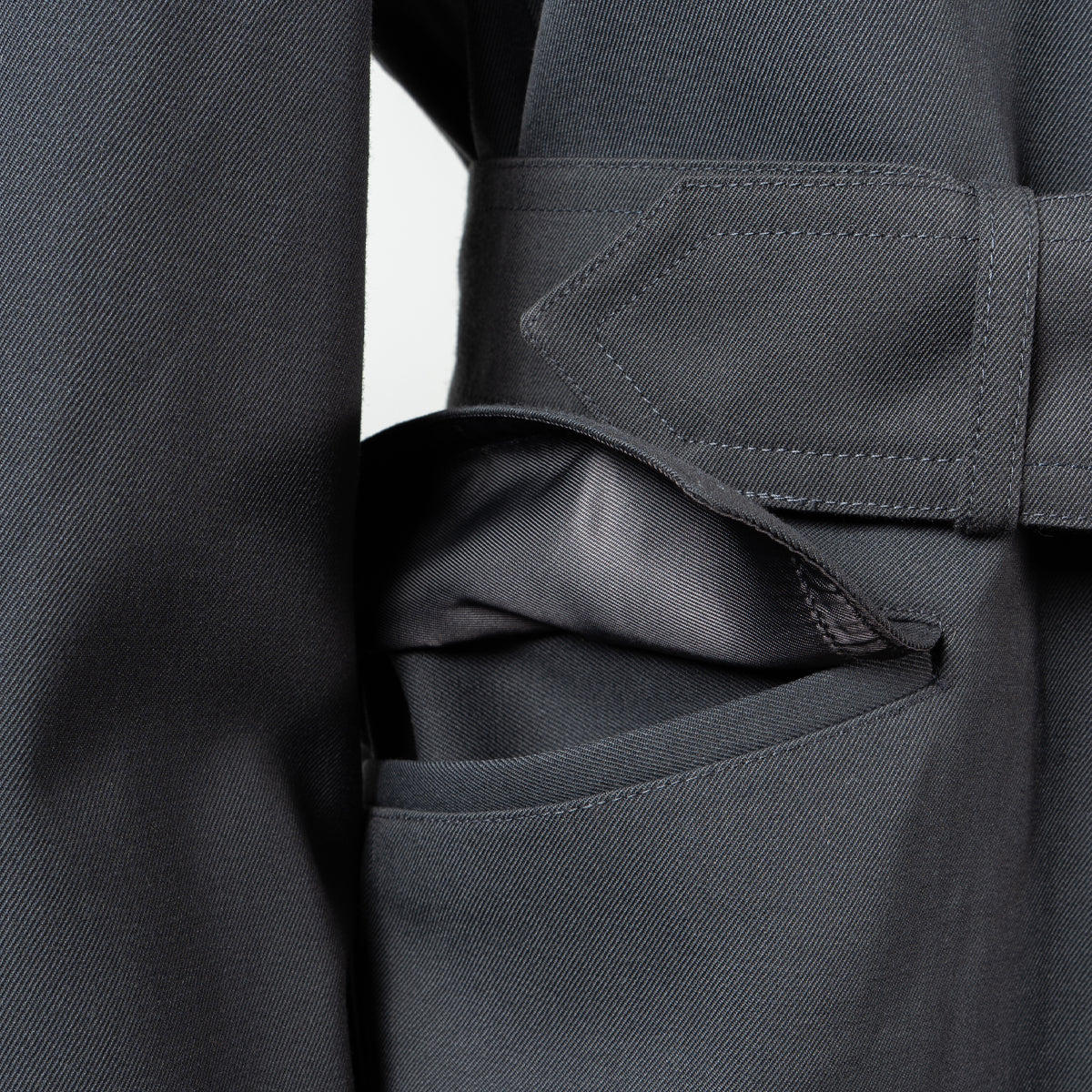 Side view focusing on the large, practical flap pocket detail found on the German Army trench coat.