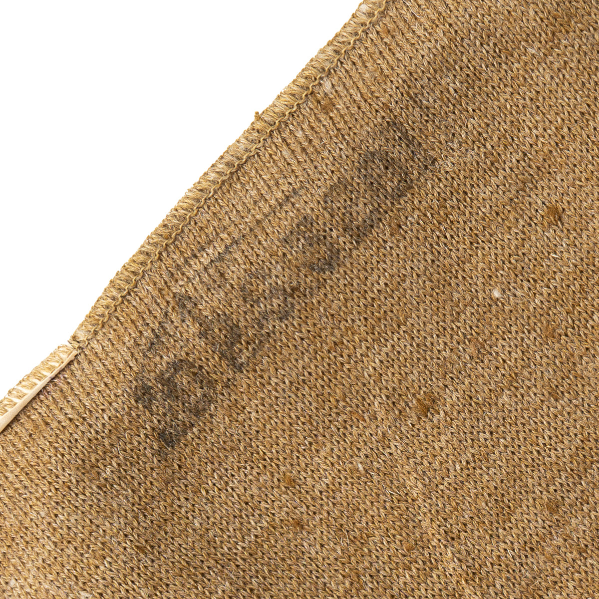 A close-up view of the original ink stamp on the brown woollen fabric of the British Army cap comforter.