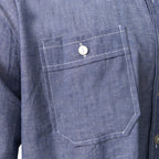 Close-up detail of the buttoned chest pocket on the blue cotton Bundesmarine German Navy shirt, highlighting the high-quality contrasting white stitching.