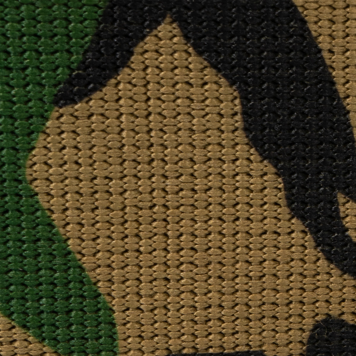 Detailed view of the high-quality woven polyester fabric showing the classic woodland camouflage pattern.