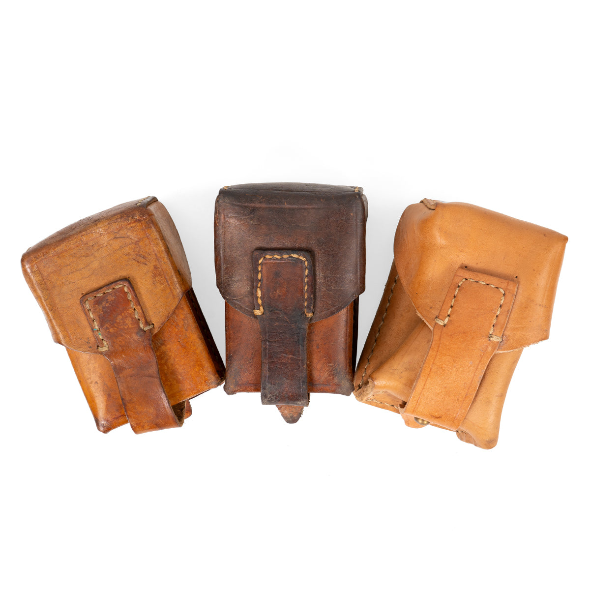 Collection of three original Serbian Army leather pouches displaying natural vintage wear, color variations, and faded leather textures.