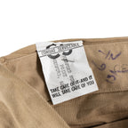 Interior view of a WW2 Garrison Cap with the 'Combat Serviceable' tag and slogan printed on white fabric.