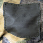 Close-up of the official military label inside the Dutch Army DPM MOLLE pouch with NSN and care instructions.